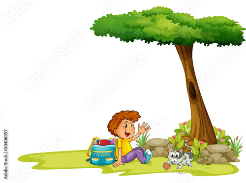 A boy and his cat under the tree