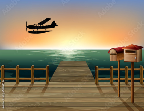 A sunset at the port with two wooden mailboxes