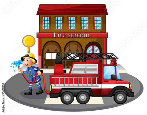 A fireman holding a water hose beside a fire truck