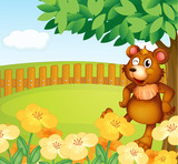 A bear standing near the flowers