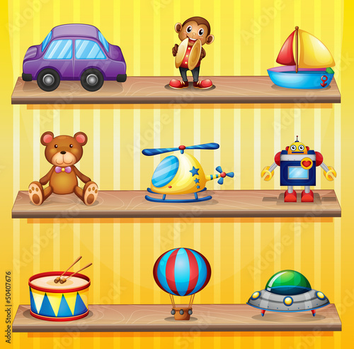 Different toys arranged at the wooden shelves