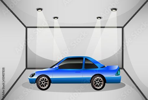 A blue tinted car inside the garage