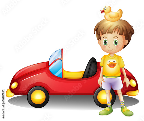 A young boy with a rubber duck and a big toy car