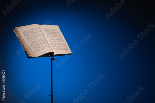 Music stand with vintage piano music - space for text