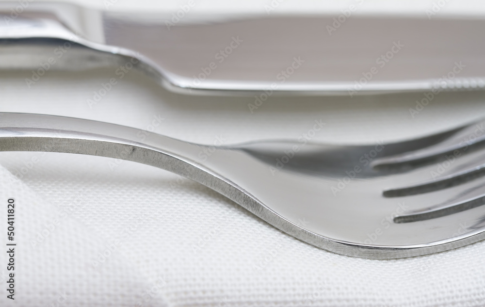 Close up image of cutlery on white napkin Close up image of cutlery on white napkin