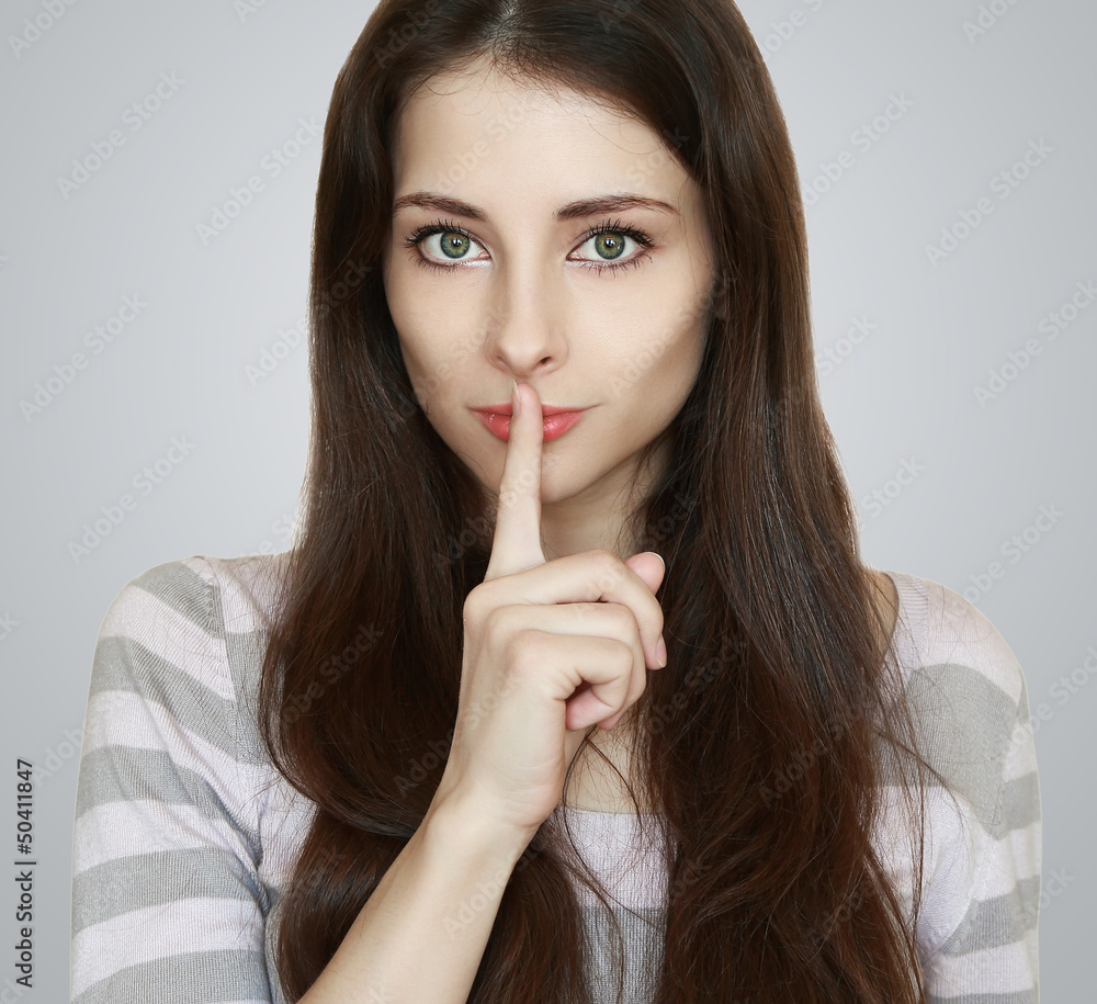 Beautiful woman with secret holding finger over lips Beautiful woman with secret holding finger over lips