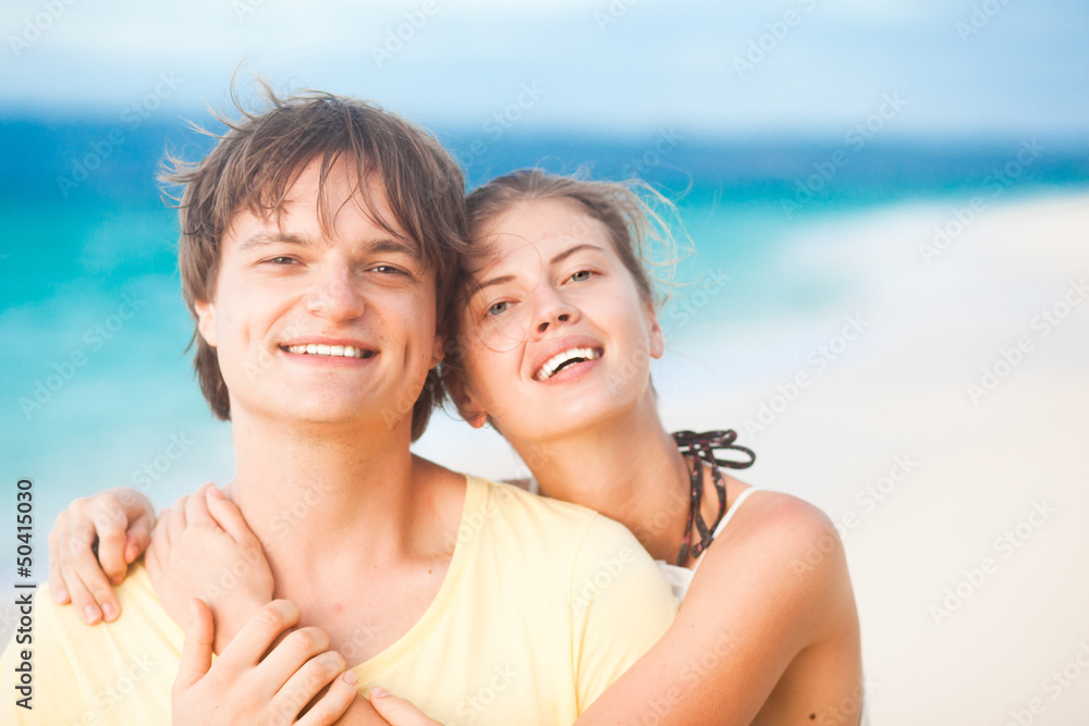 portrait of young happy couple having fun on tropical beach. portrait of young happy couple having fun on tropical beach.