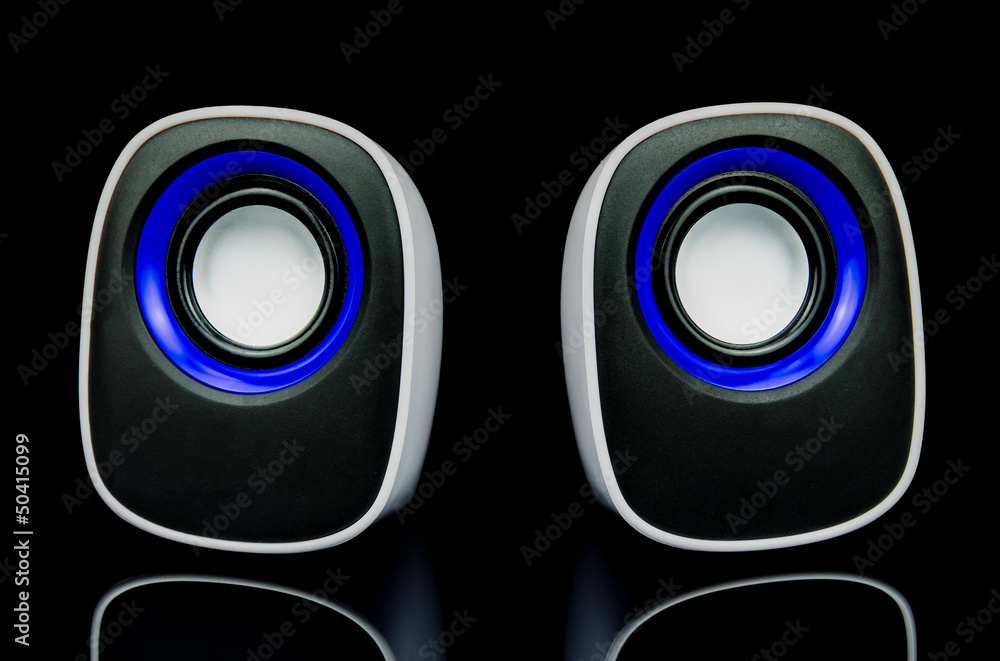 white speakers with reflection on black background white speakers with reflection on black background