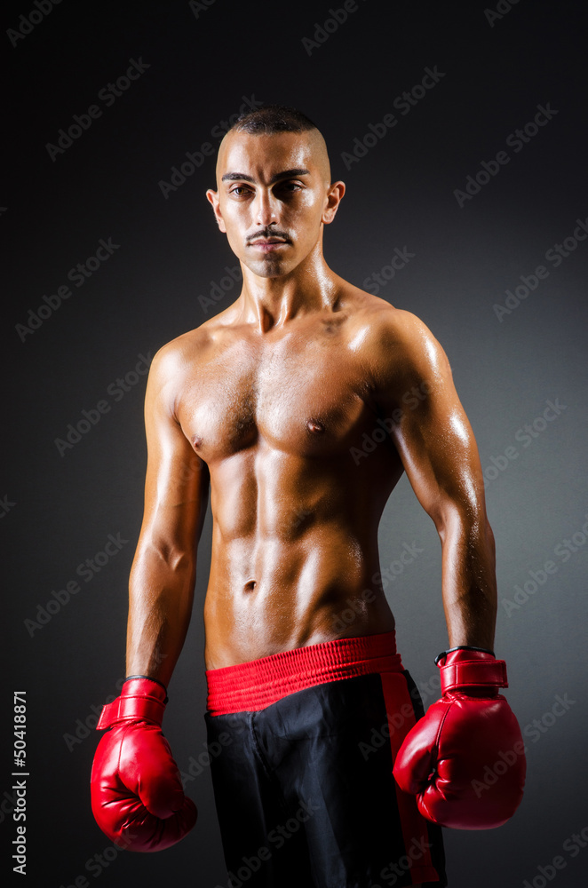 Muscular boxer in studio shooting