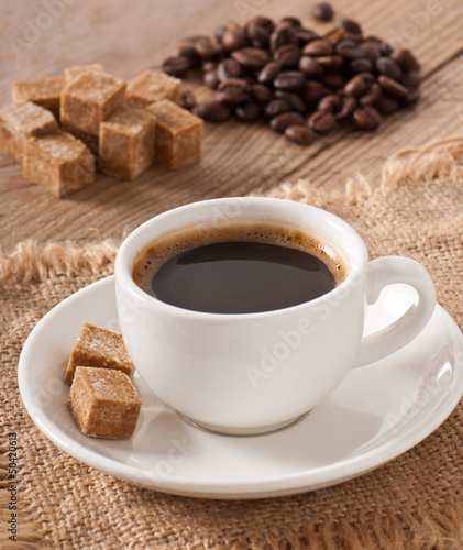 Cubes brown sugar and cup of coffee