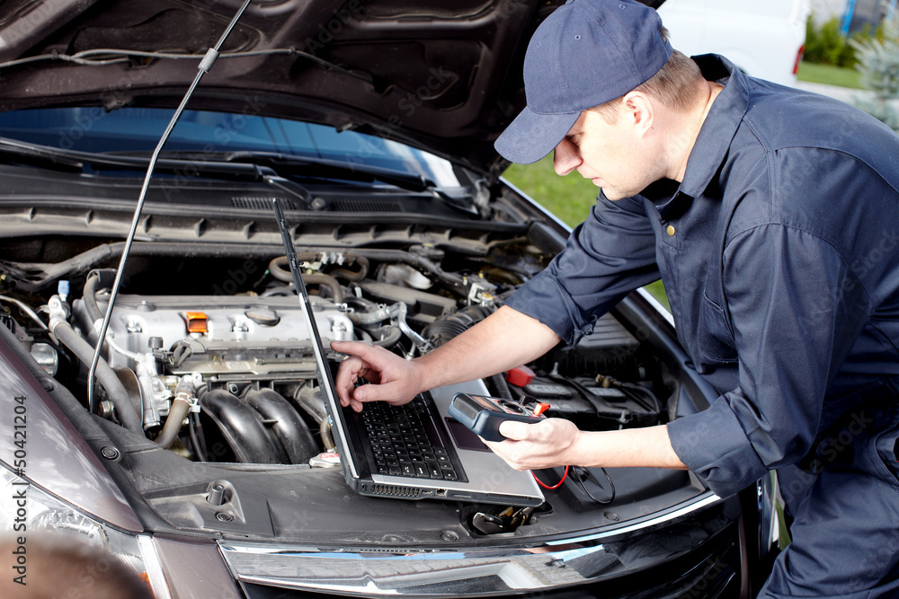 Car mechanic working in auto repair service.
