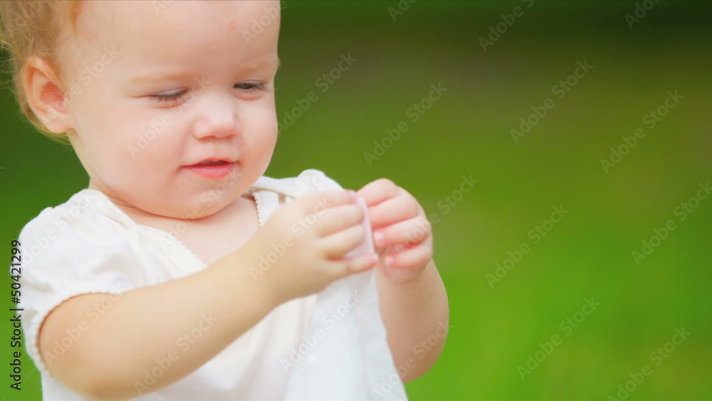 Close up of little Caucasian kid sitting on blanket Close up of little Caucasian kid sitting on blanket