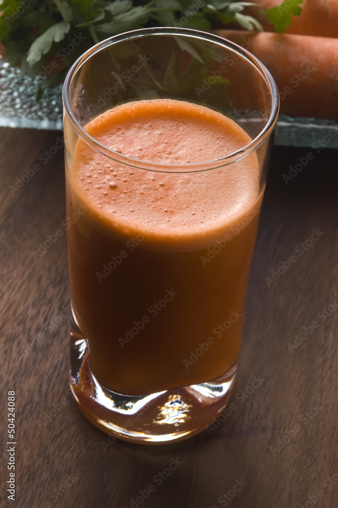 carrot juice on a wooden background carrot juice on a wooden background