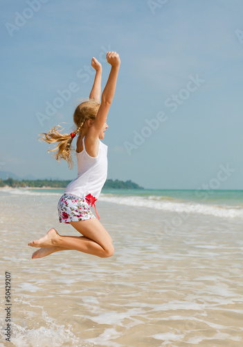 flying jump beach girl on blue sea shore in summer vacation