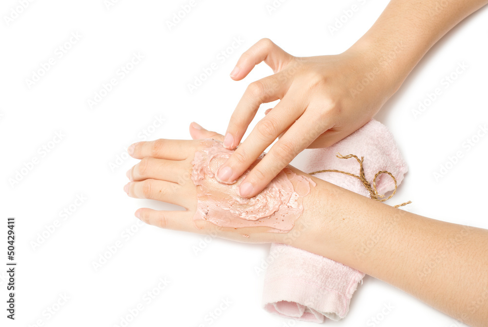 Naklejka premium woman hand applying spa cream on white background.