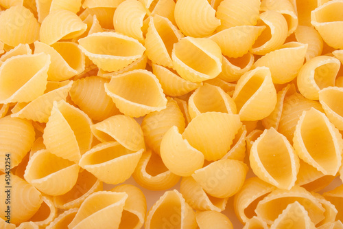 Pasta background, yellow macaroni, food ingredient photo