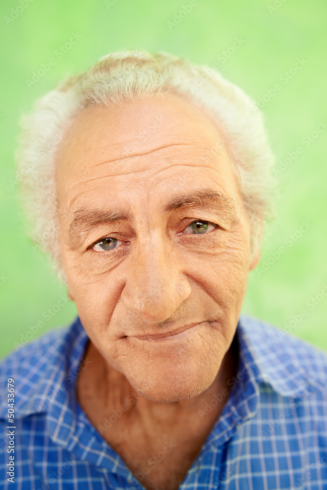 Portrait of happy elderly caucasian man smiling at camera Portrait of happy elderly caucasian man smiling at camera