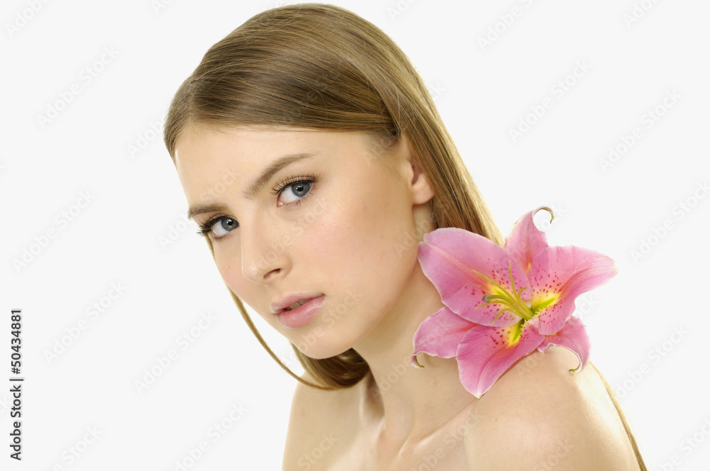 young girl holding pink lily flower in her hands