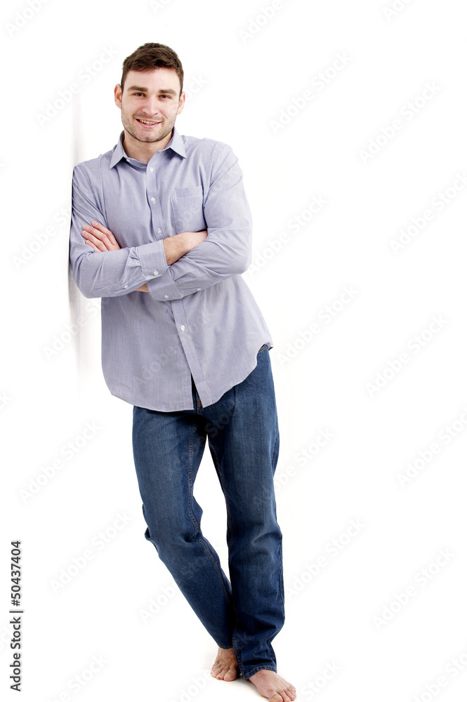 Handsome man leaning against a white wall Handsome man leaning against a white wall