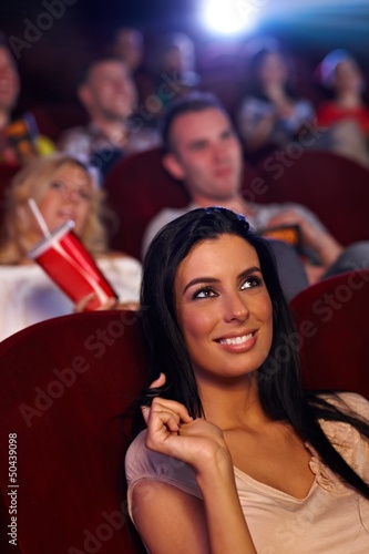 Beautiful girl in cinema smiling