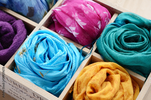 Set of colorful scarfs in wooden box