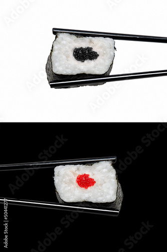 Sushi in The Chopsticks. Typical Japanese Food. Rice Rolls