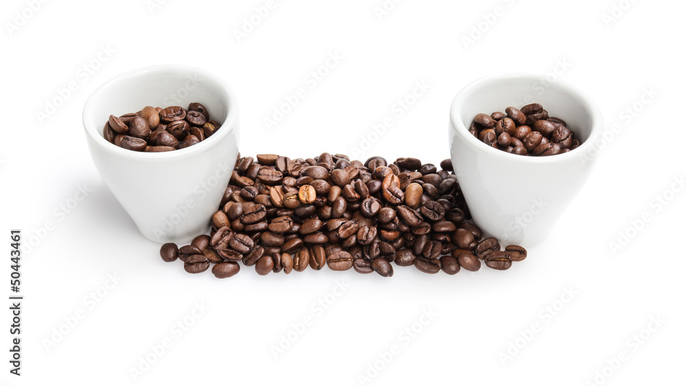 heap of coffee beans with two cups heap of coffee beans with two cups