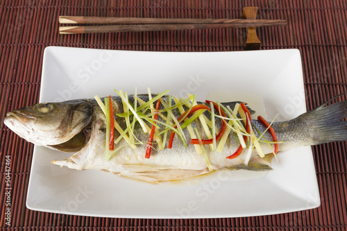 Chinese style steamed sea bass with ginger, chili & spring onion photo