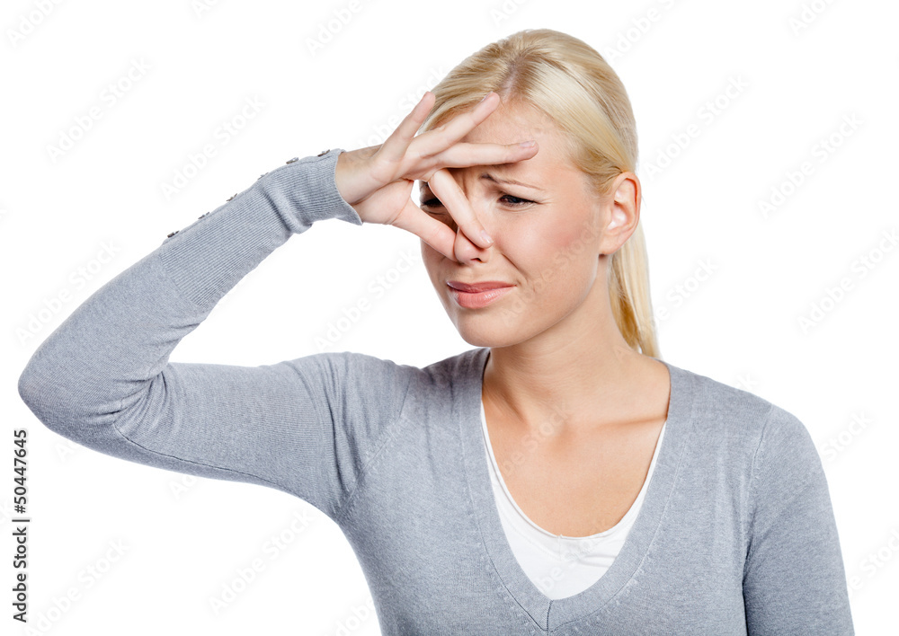 Woman covers nose with hand showing that something stinks Woman covers nose with hand showing that something stinks