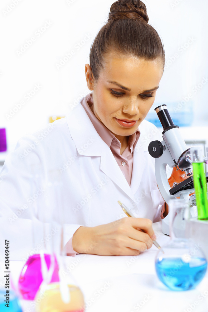Fototapeta premium Young female scientist working in laboratory