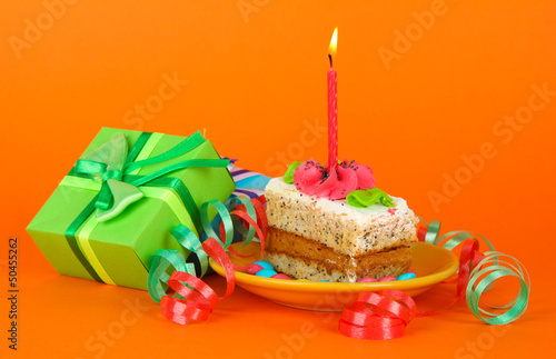 Colorful birthday cake with candle and gifts