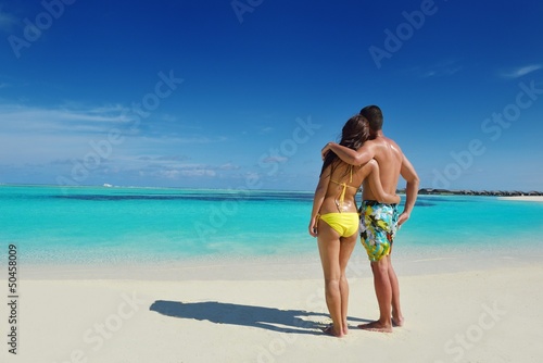 happy young couple enjoying summer on beach