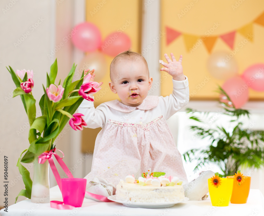 baby girl celebrating first birthday and eating cake baby girl celebrating first birthday and eating cake