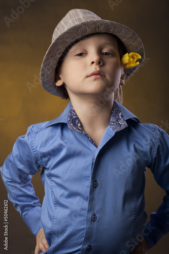 bly in a hat and yellow tulip photo