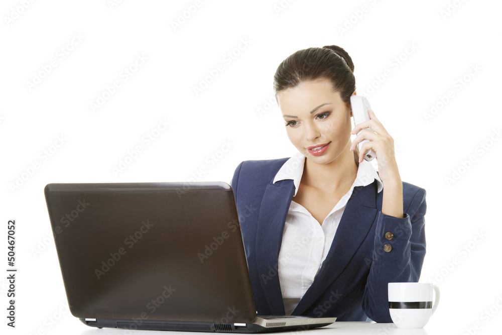 Smiling young business woman speaking on phone Smiling young business woman speaking on phone
