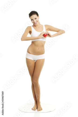 Happy Fit female with red heart shaped toy © Piotr Marcinski