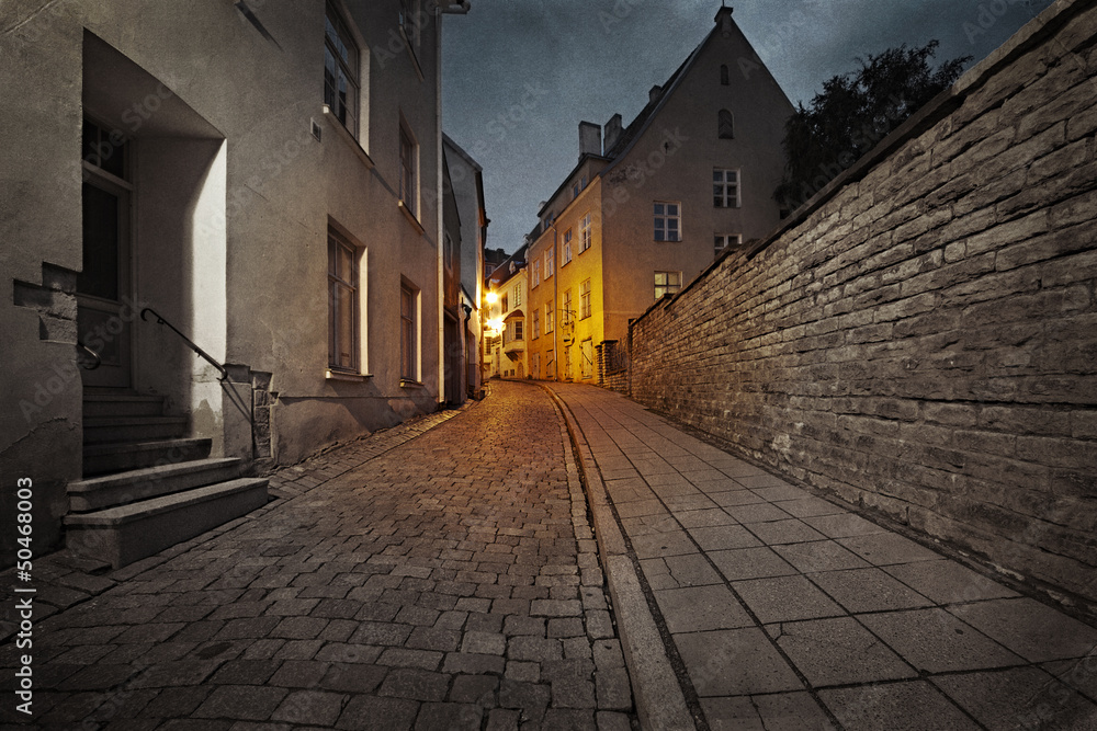 Retro style photo of old European street at night