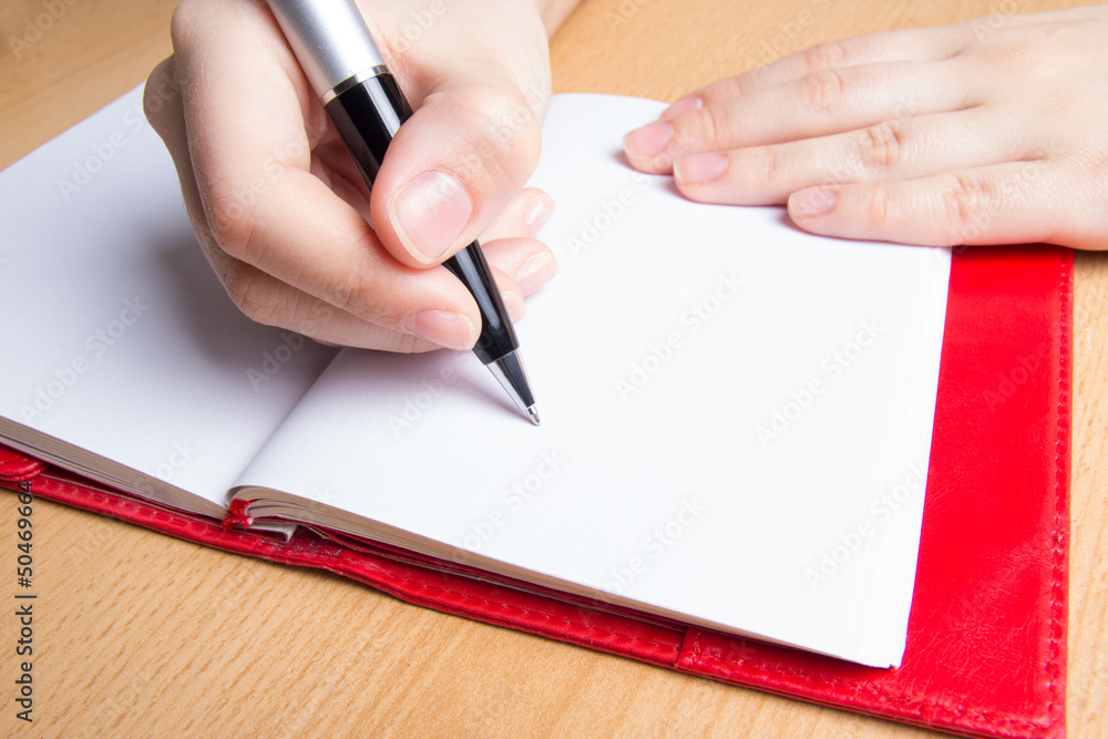 hand writing in red notebook hand writing in red notebook