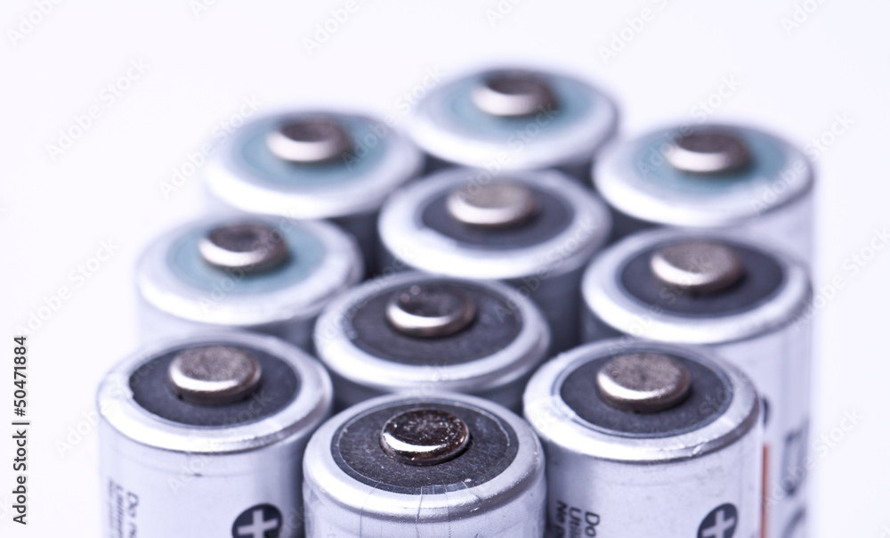Several AA batteries in perspective closeup view on white backgr Several AA batteries in perspective closeup view on white backgr
