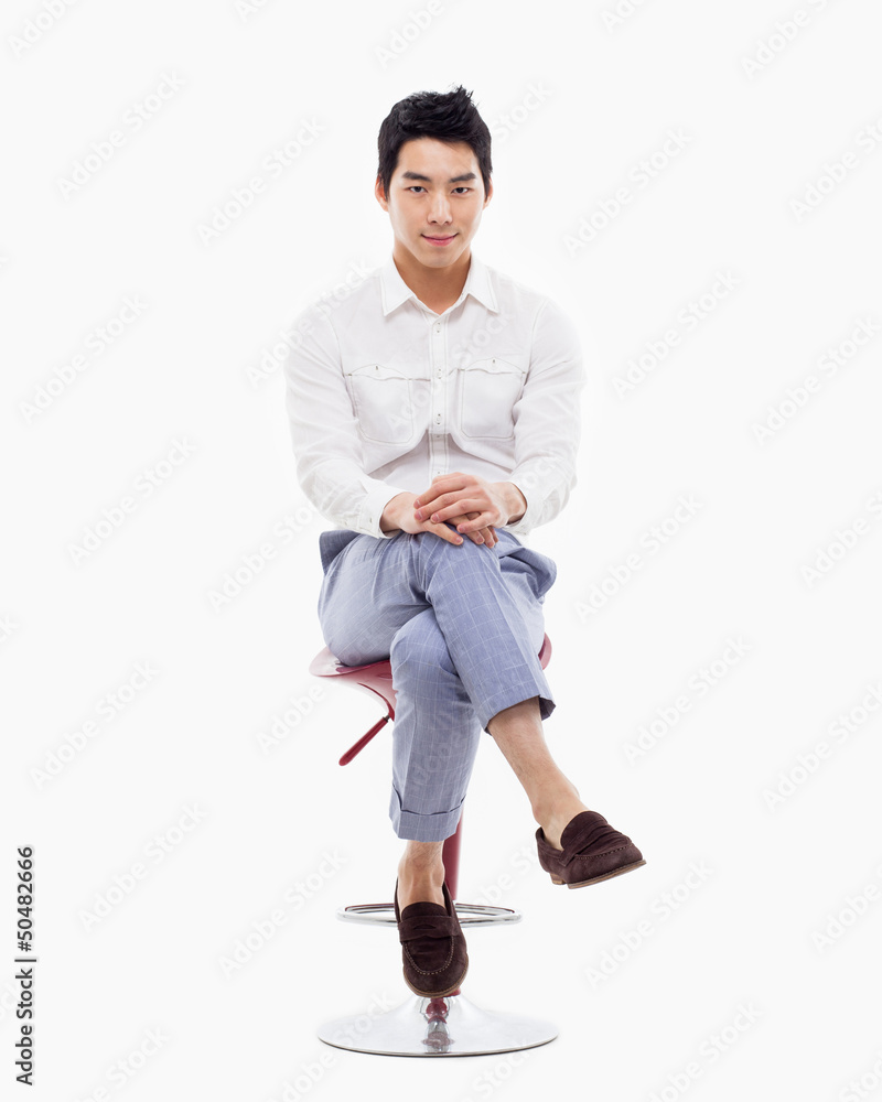 Naklejka premium Young Asian person sitting on the chair.