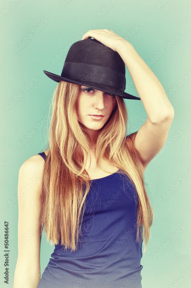 Portrait of beautiful young woman in black hat. Portrait of beautiful young woman in black hat.