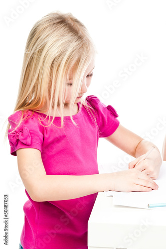 Small and beautiful girl draws pencil