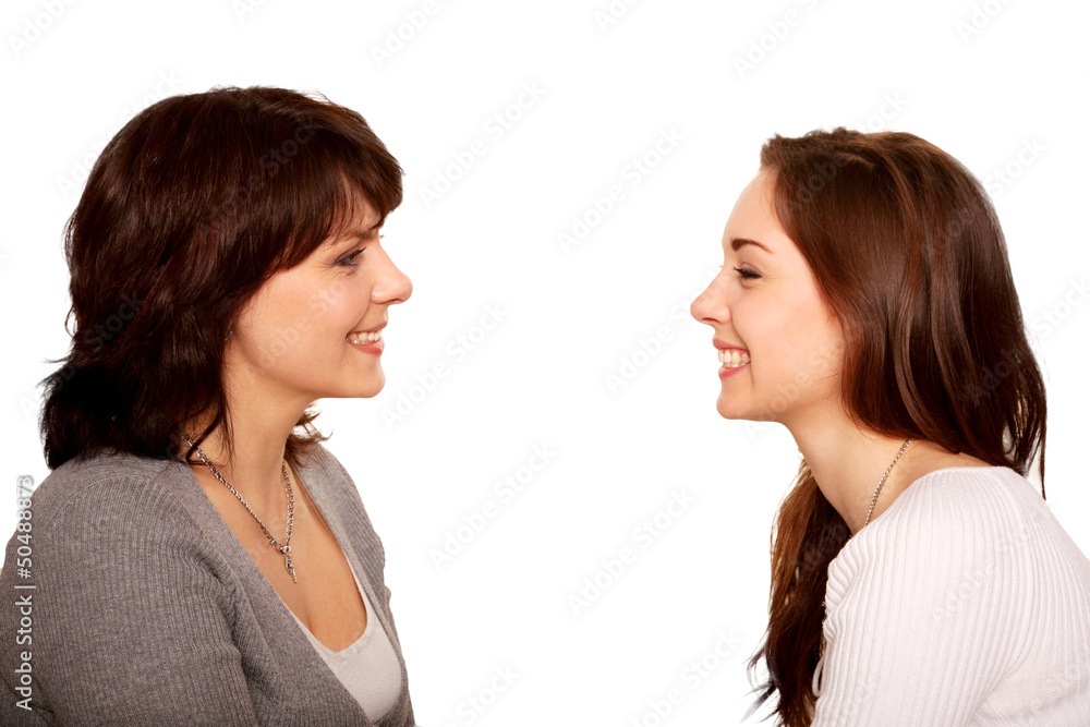 Mother and teenage daughter talking and laughing together. Mother and teenage daughter talking and laughing together.