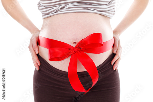 Pregnant woman belly with red bow