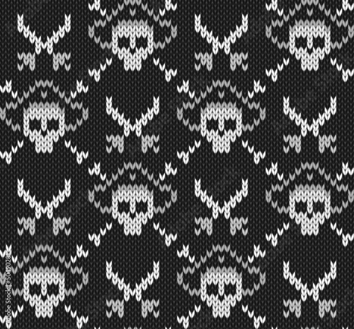 Knitted background with skulls