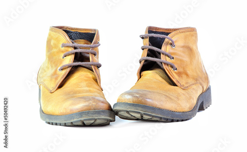 Pair of shabby leather boots isolated