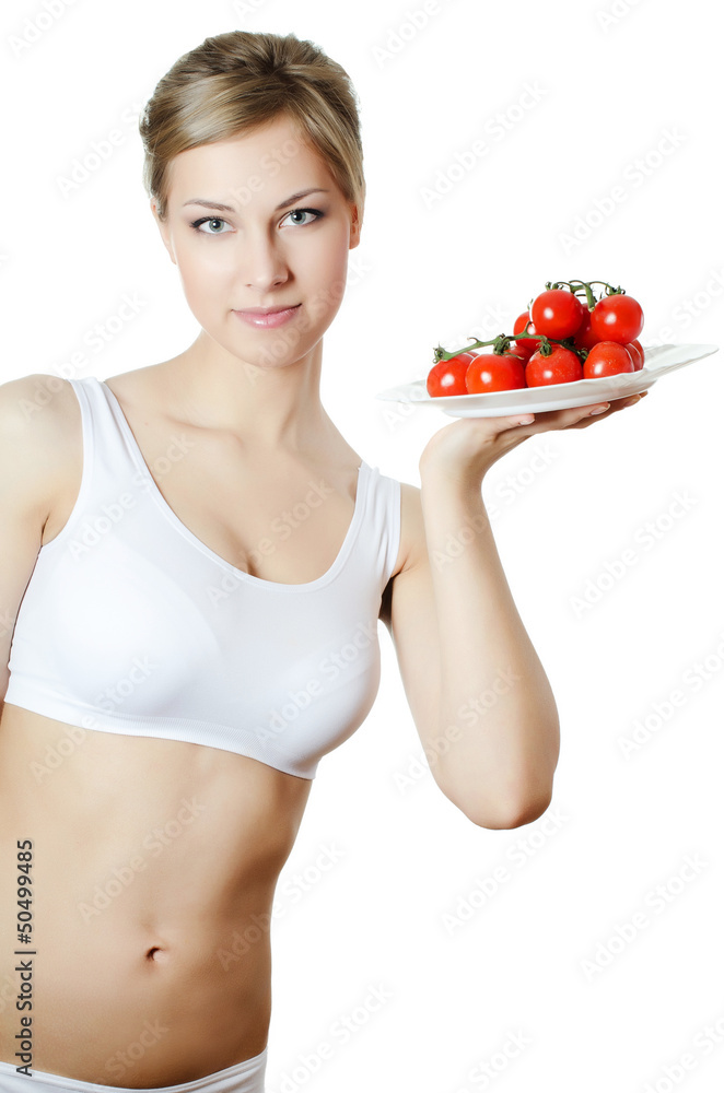 The beautiful girl with a plate with vegetables The beautiful girl with a plate with vegetables
