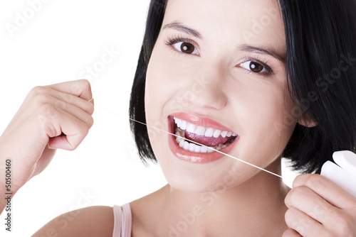 Beautiful woman using dental floss