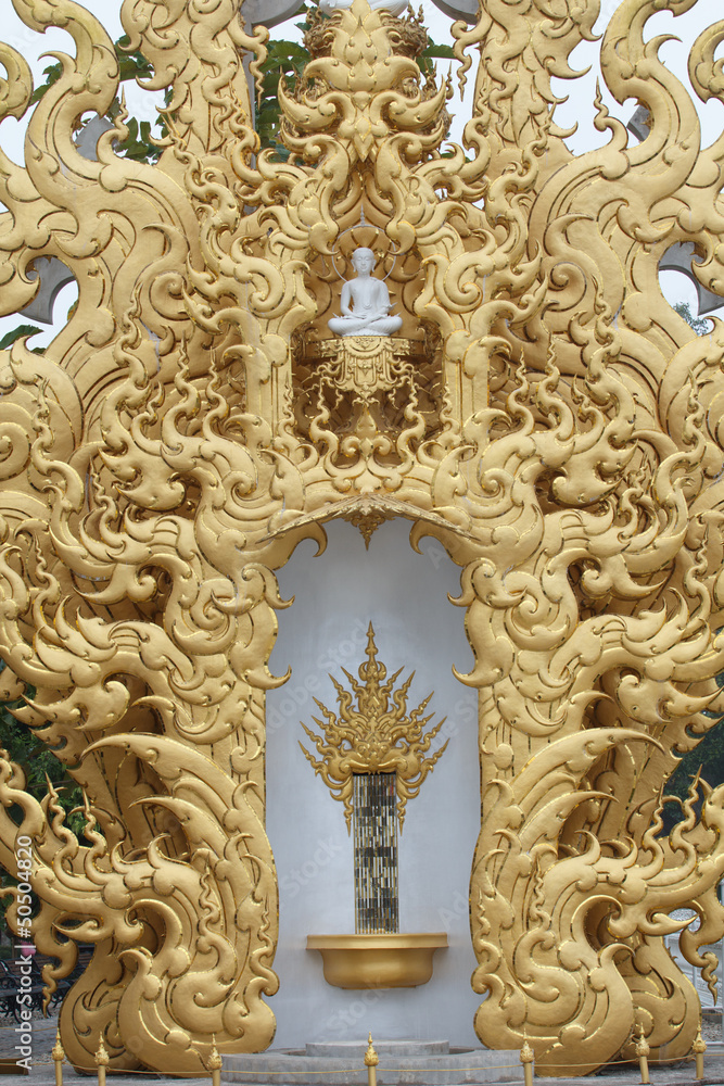 White Buddha statue in a gold frame