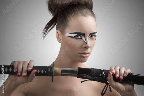 brunette in japan style with katana turned of three quarters